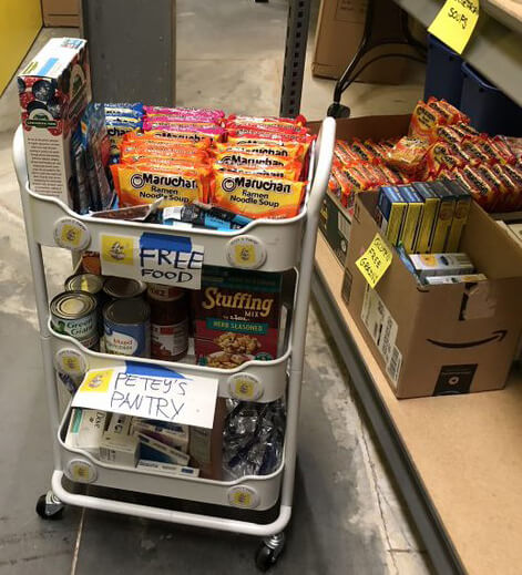 A cart is filled with free food from Petey's Pantry for students to choose from.